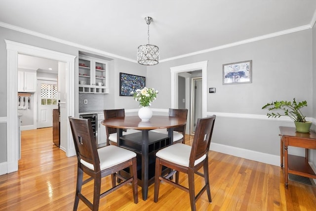 72 Edgecliff Rd Unit 72, Watertown, MA 02472 - dining room with light wood-style floors, crown molding, a chandelier, and baseboards
