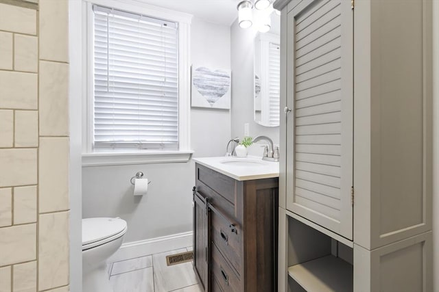 72 Edgecliff Rd Unit 72, Watertown, MA 02472 - bathroom with vanity, toilet, baseboards, and marble look tiles
