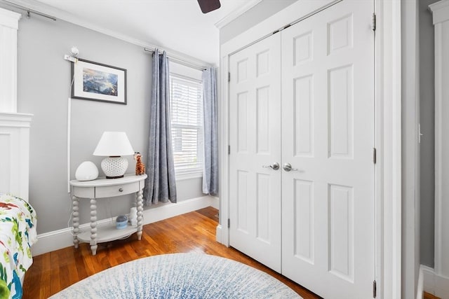72 Edgecliff Rd Unit 72, Watertown, MA 02472 - bedroom with a closet, baseboards, wood finished floors, ceiling fan, and ornamental molding