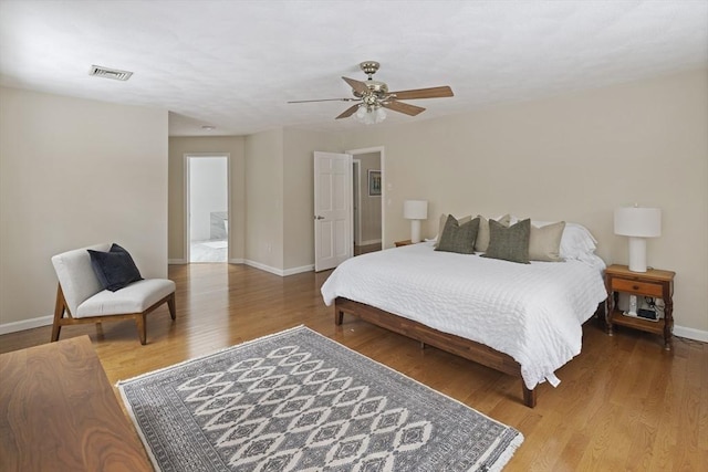 bedroom with visible vents, ceiling fan, baseboards, and wood finished floors