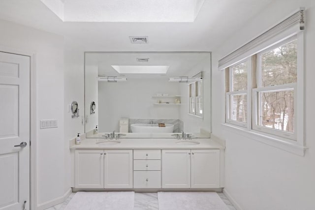 bathroom featuring double vanity, baseboards, visible vents, and a sink