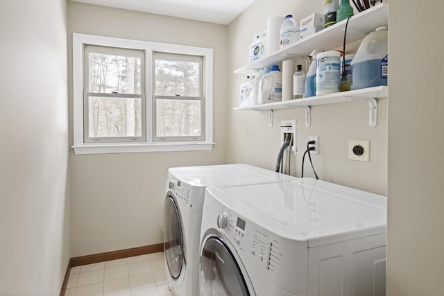 laundry room with washer and dryer, laundry area, light tile patterned flooring, and baseboards