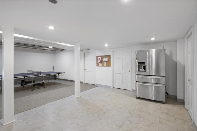 interior space with baseboards, stainless steel refrigerator with ice dispenser, and recessed lighting