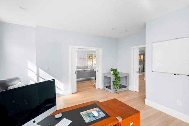 office space with recessed lighting, wood finished floors, and baseboards