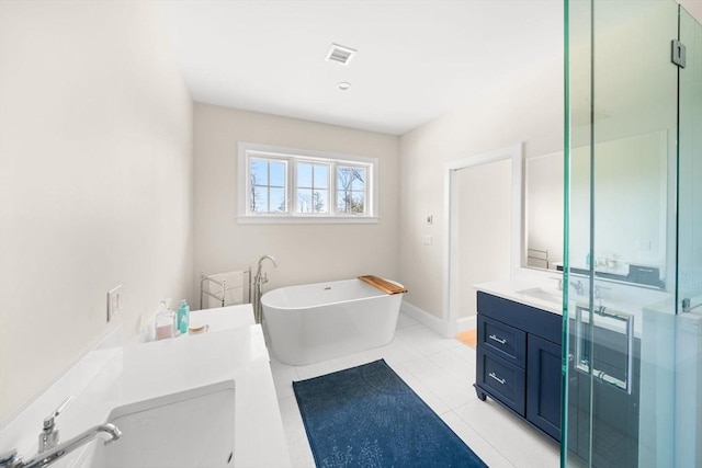 bathroom featuring tile patterned floors, a freestanding tub, visible vents, a shower stall, and vanity