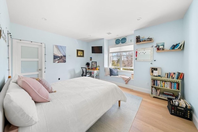 bedroom featuring baseboards and wood finished floors