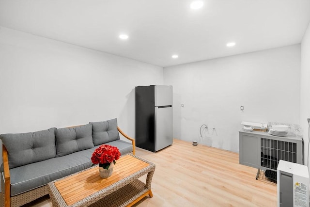 living area featuring recessed lighting and light wood-style flooring