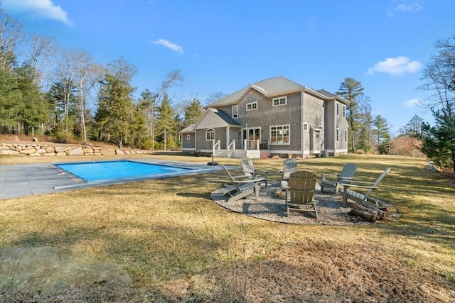 view of swimming pool with a yard, a fire pit, a covered pool, and a patio area