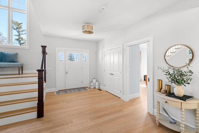 entrance foyer with plenty of natural light, light wood-type flooring, and baseboards