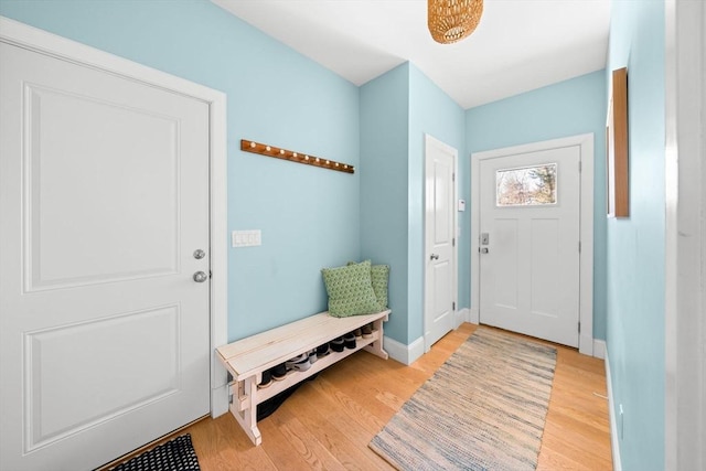 mudroom with baseboards and light wood-style flooring