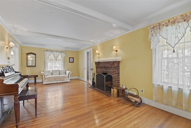 living room featuring a fireplace, wood-type flooring, beamed ceiling, and crown molding