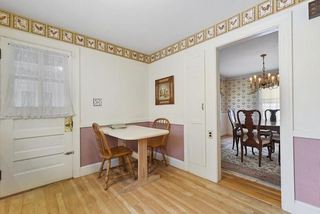 dining space featuring hardwood / wood-style flooring and a notable chandelier