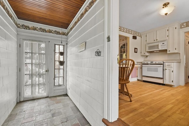 interior space with light hardwood / wood-style floors and wood ceiling