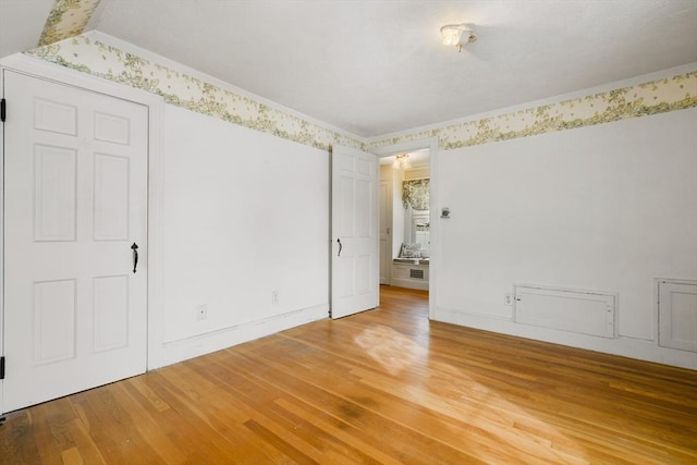 unfurnished bedroom featuring hardwood / wood-style flooring