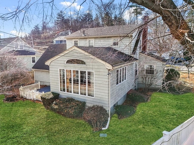 rear view of property with a lawn