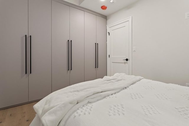 bedroom with light wood-type flooring