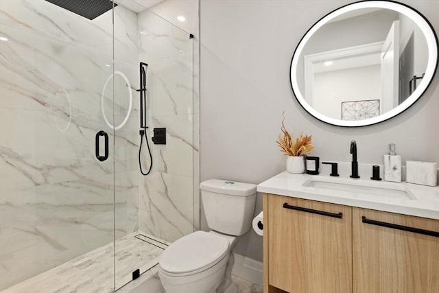 bathroom with vanity, toilet, and a shower with shower door