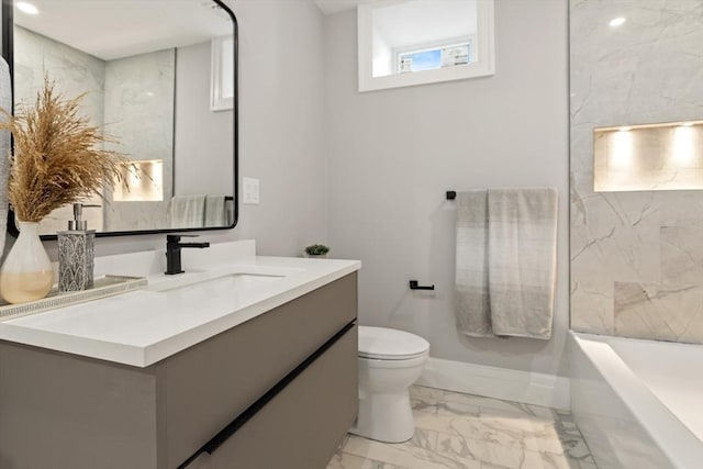 bathroom featuring vanity, toilet, and a bathing tub