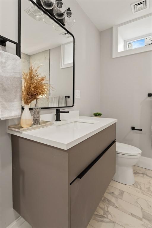 bathroom featuring vanity and toilet