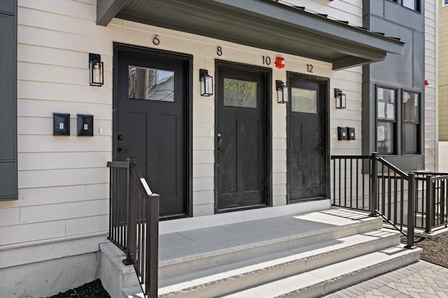 view of exterior entry featuring covered porch