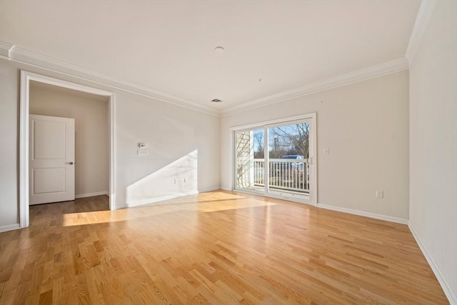 empty room featuring crown molding and light wood-type flooring