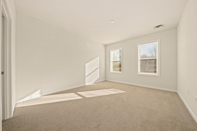 spare room with light colored carpet