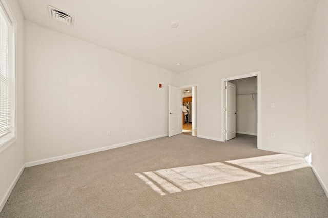 unfurnished bedroom with carpet and a closet