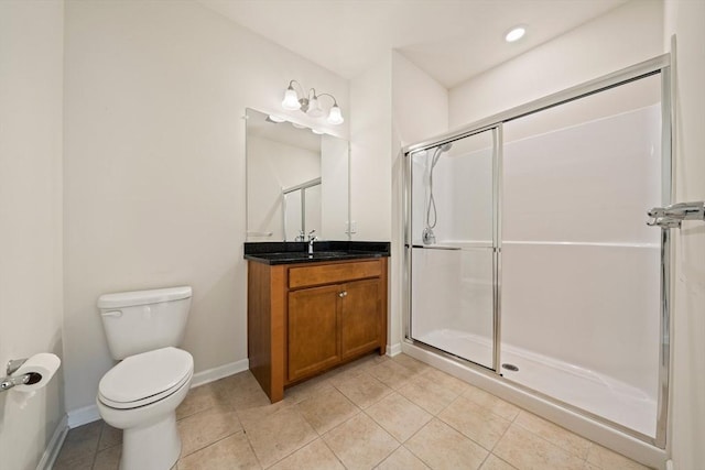 bathroom with toilet, tile patterned flooring, a shower with shower door, and vanity