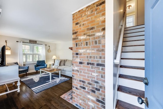 living area featuring stairway and wood finished floors