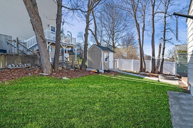 view of yard featuring a storage shed, an outbuilding, and a fenced backyard