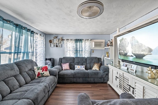 living area featuring an AC wall unit and dark wood finished floors