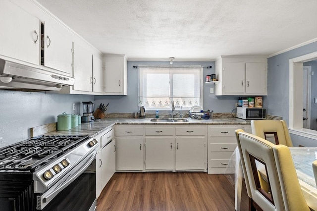 kitchen featuring white cabinetry, under cabinet range hood, dark wood-type flooring, stainless steel gas stove, and a sink