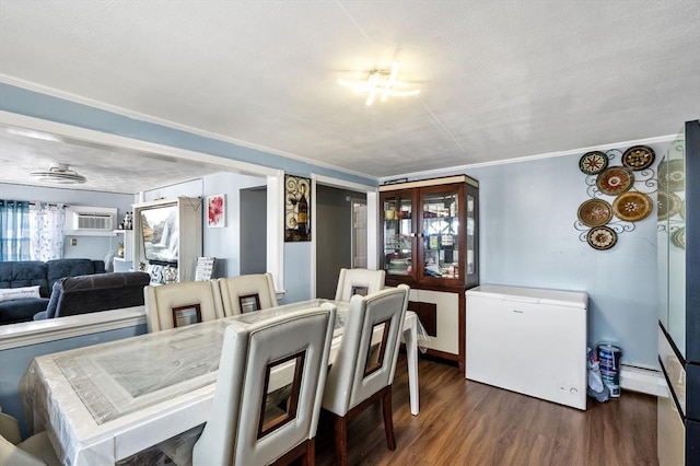 dining space featuring dark wood-type flooring, ornamental molding, and baseboard heating