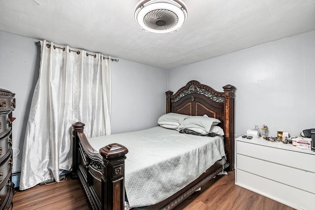 bedroom featuring visible vents and wood finished floors