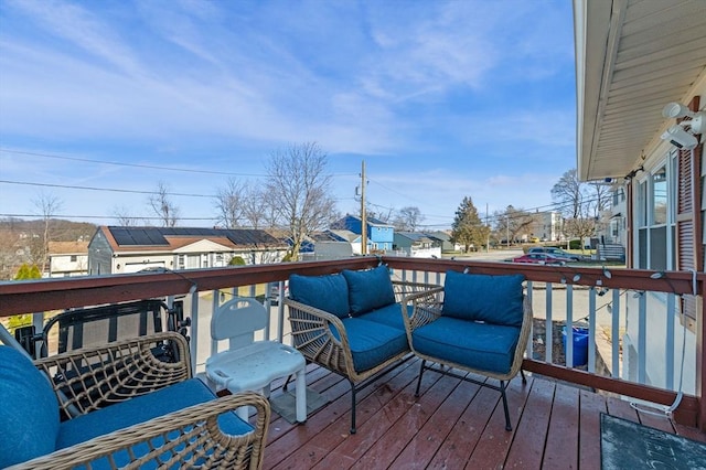 wooden deck with an outdoor hangout area and a residential view