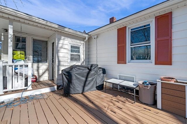 wooden terrace featuring a grill