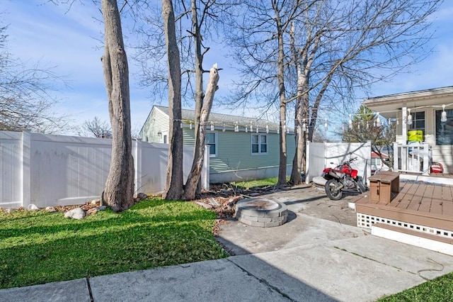 view of yard with an outdoor fire pit and fence