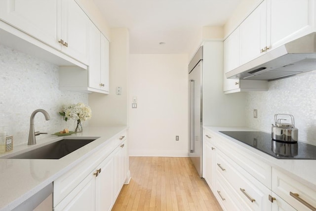 kitchen with sink, white cabinets, and tasteful backsplash