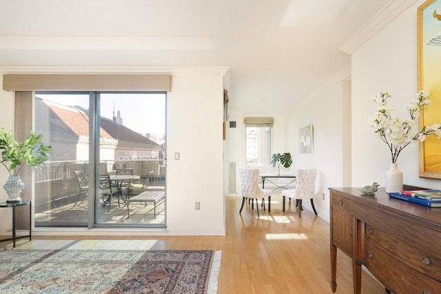 doorway to outside with hardwood / wood-style flooring and ornamental molding