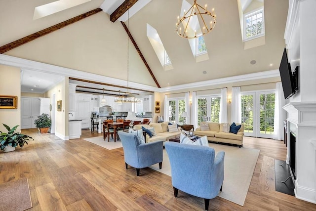 10 Herring Gull Rd, Mashpee, MA 02649 - living area with high vaulted ceiling, a chandelier, a skylight, healthy amount of natural light, and beam ceiling