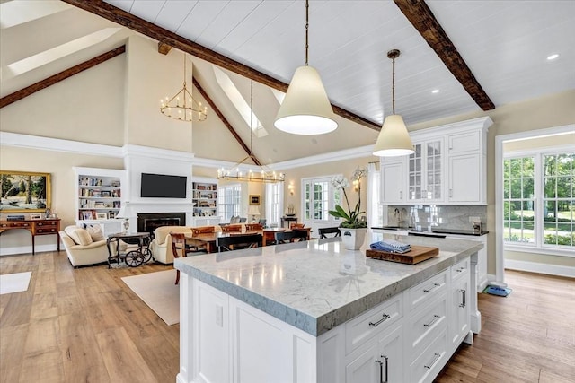 10 Herring Gull Rd, Mashpee, MA 02649 - kitchen featuring light wood-style flooring, decorative light fixtures, glass insert cabinets, white cabinetry, and recessed lighting