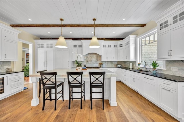 10 Herring Gull Rd, Mashpee, MA 02649 - kitchen with decorative backsplash, light wood-style flooring, white cabinets, a wood ceiling with exposed beams, and recessed lighting