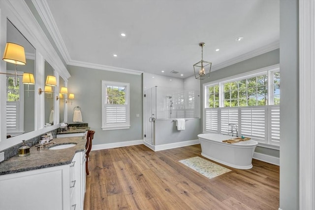 10 Herring Gull Rd, Mashpee, MA 02649 - bathroom with vanity, ornamental molding, a shower stall, a freestanding bath, and wood finished floors