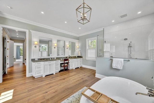 10 Herring Gull Rd, Mashpee, MA 02649 - full bath featuring double vanity, a soaking tub, walk in shower, ornamental molding, and wood finished floors