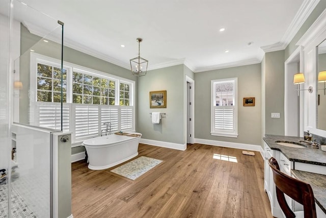 10 Herring Gull Rd, Mashpee, MA 02649 - full bath with a freestanding tub, wood-type flooring, vanity, plenty of natural light, and crown molding