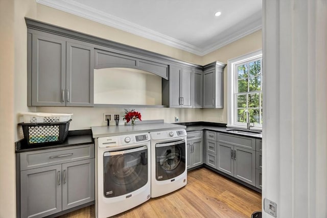 10 Herring Gull Rd, Mashpee, MA 02649 - laundry area featuring cabinet space, separate washer and dryer, ornamental molding, and light wood-style flooring
