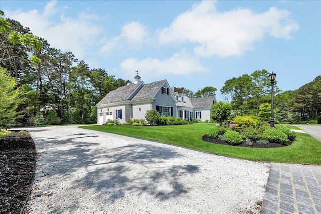 10 Herring Gull Rd, Mashpee, MA 02649 - view of home's exterior featuring a yard, a garage, a chimney, and driveway