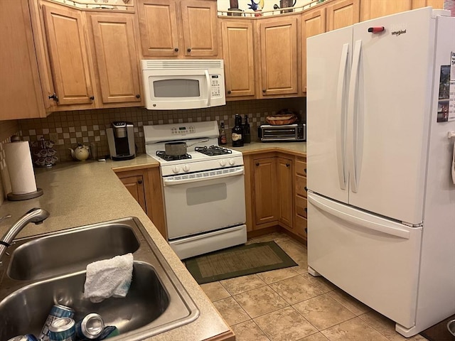 kitchen featuring sink, white appliances, light tile patterned floors, and backsplash