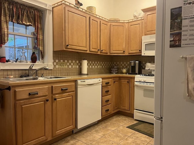 kitchen featuring light tile patterned flooring, light brown cabinetry, sink, tasteful backsplash, and white appliances