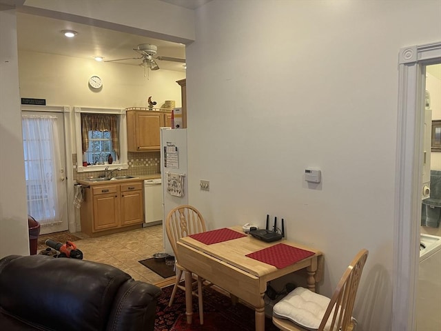 tiled dining room with ceiling fan and sink